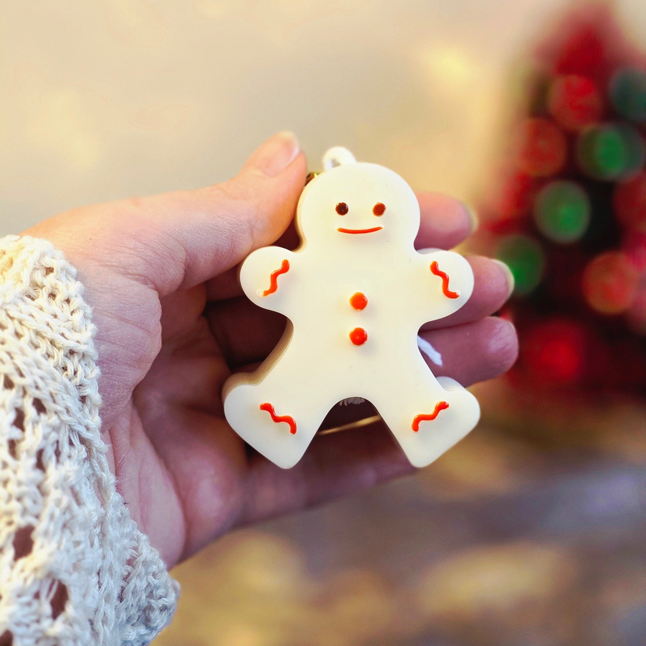 Kerst cadeauset met witte figuurkaarsen: rendier, kerstboom en gingerbread in gouden doos met rood lint en gouden belletjes